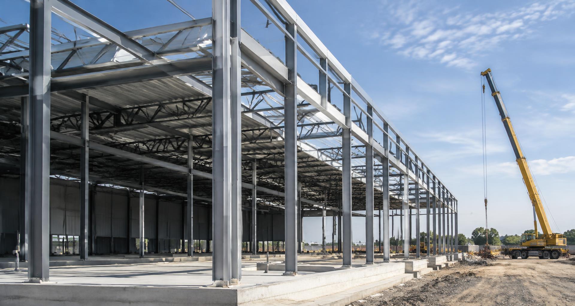 Structural steel framing and a crane at an industrial construction site